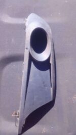 Right side spotlight cover for Volkswagen Jetta 6, angled view, used condition showing minor wear.Right side s