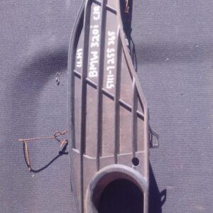 Left side headlight cover for BMW F30, used condition, shown at slight angle, black plastic housing.Left side