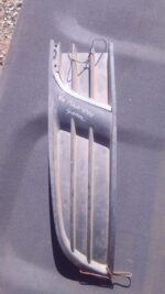 Left front spotlight cover for Volkswagen Polo Vivo, shown used, angled slightly from the side against white b