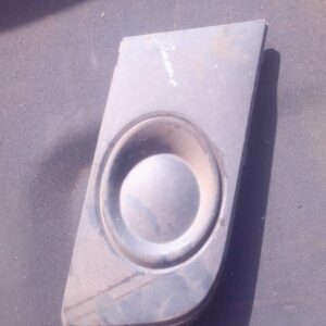 Right spotlight cover for Volkswagen Amarok, angled side view, used condition visible surface.Right spotlight