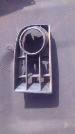 Left headlight cover for Volkswagen Golf 5 viewed from front angle, used condition.Left headlight cover for Vo