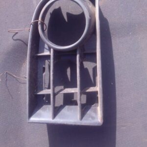 Left headlight cover for Volkswagen Golf 5 viewed from front angle, used condition.Left headlight cover for Vo