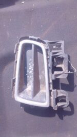 Left front spotlight cover for Mazda 6, shown from angled front view, used condition.Left front spotlight cove