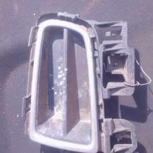 Left front spotlight cover for Mazda 6, shown from angled front view, used condition.Left front spotlight cove