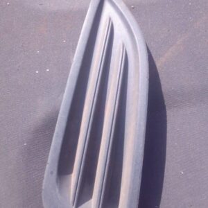 Left headlight cover for Ford Fiesta shown from front angle, used condition.Left headlight cover for Ford Fies