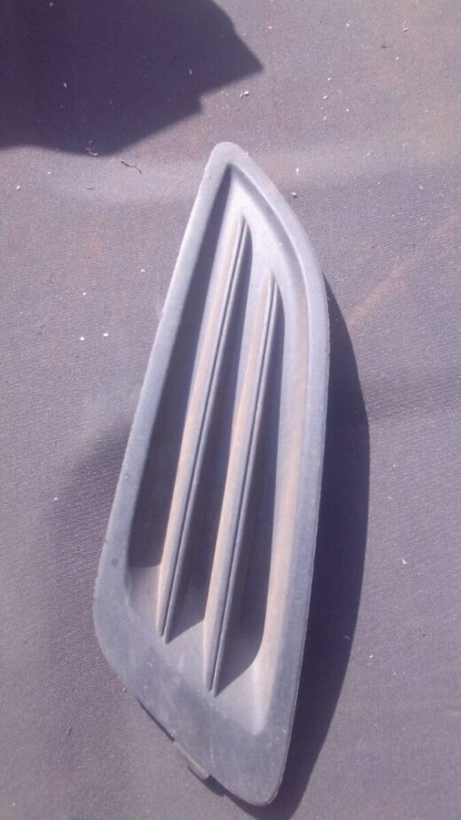 2014 Ford Fiesta Left Spotlight Cover - Used Left headlight cover for Ford Fiesta shown from front angle, used condition.Left headlight cover for Ford Fies