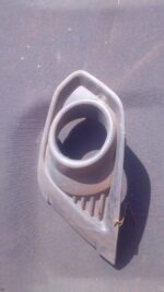 Left front spotlight cover for 2013 Ford Figo, used, shown from front angle on white background.Left front spo