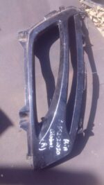 Right-side spotlight cover for Kia Optima, angled view, used condition.Right-side spotlight cover for Kia Opti