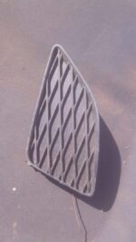 Left spotlight cover for Toyota Corolla, shown front angle, used condition visible.Left spotlight cover for To