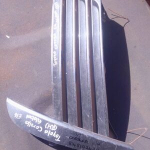 Right-side car spotlight cover for Toyota Corolla, shown front angle, used condition with minor wear.Right-sid