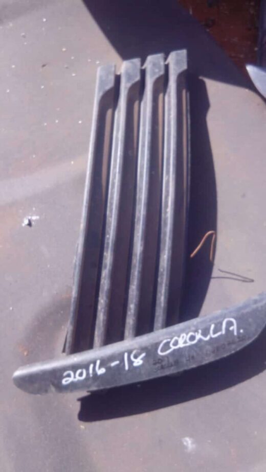 2017 Toyota Corolla Left Spotlight Cover - Used Left side spotlight cover for 2017 Toyota Corolla shown from front angle, used condition.Left side spotlight c