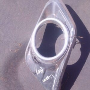 Front view of a used Nissan car spotlight cover showing clear lens and black housing.Front view of a used Niss