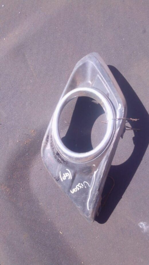 Nissan Spotlight Cover - Used Front view of a used Nissan car spotlight cover showing clear lens and black housing.Front view of a used Niss