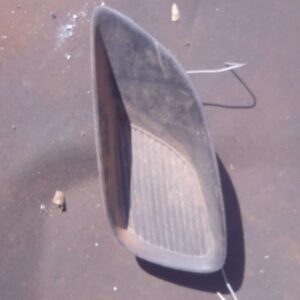 Left side headlight cover for Toyota Yaris, front angle view, used condition, clean surface with minor wear.Le