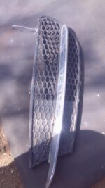 Left spotlight cover for Alfa 147, shown from front angle, used condition with minor wear visible.Left spotlig