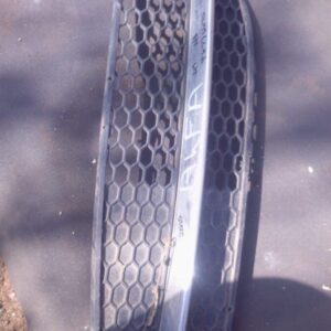 Left spotlight cover for Alfa 147, shown from front angle, used condition with minor wear visible.Left spotlig