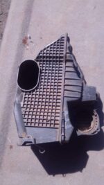 Used air filter housing for Renault Duster shown from a top angle highlighting the housing and attached hose.U