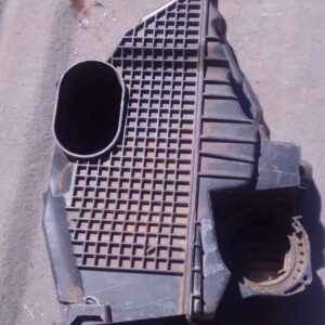 Used air filter housing for Renault Duster shown from a top angle highlighting the housing and attached hose.U