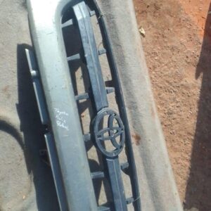Front view of a used Toyota Hilux main grille with horizontal slats and chrome accents.Front view of a used To