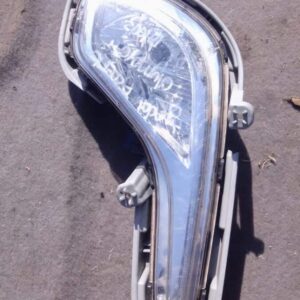 Left headlight spotlight assembly for Hyundai Accent, shown from front left angle, used condition.Left headlig