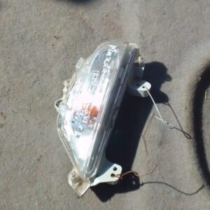 Right front spotlight for Mazda 3 shown from front-right angle, used condition with clear lens and mounting po