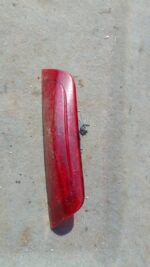 Rear brake light assembly for Nissan Micra 3rd gen, shown from the back, used condition.Rear brake light assem