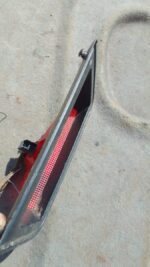 Used third brake light for a 2006 Nissan Tiida, shown front-facing with mounting points visible.Used third bra