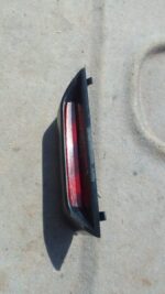 Rear view of a used 3rd brake light for a Lexus IS200, showing the lens and mounting points.Rear view of a use