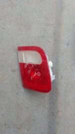Right inner taillight for BMW E46 shown close-up, used condition with clear and red lens sections visible.Righ