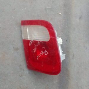 Right inner taillight for BMW E46 shown close-up, used condition with clear and red lens sections visible.Righ