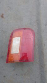Left inner taillight for Honda Ballade, angled view showing red and amber lens, used condition.Left inner tail