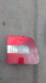 Left inner taillight for Volkswagen Polo Classic, used condition, shown from angled rear view.Left inner taill