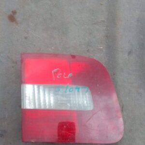 Left inner taillight for Volkswagen Polo Classic, used condition, shown from angled rear view.Left inner taill