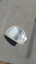 Left corner light for Fiat Palio viewed from front left, used condition, showing clear lens and amber reflecto