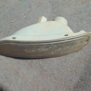 Left side used front bumper indicator light for a Kia Shuma, angled slightly to show the lens and connector.Le