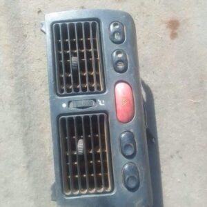 Front view of a used centre dash air vent for Fiat Sienna, showing vent slots and mounting points.Front view o