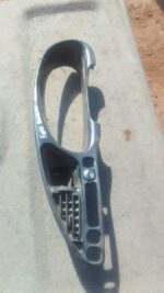 Front view of a used cluster surround for a 2006 Ford Bantam dashboard panel.Front view of a used cluster surr