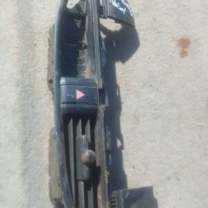 Front view of a used Kia Picanto center dash air vent showing mounting clips and vent fins.Front view of a use