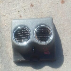 Front view of a used Peugeot 308 centre dash air vent showing air slats and mounting frame.Front view of a use