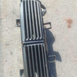 Front view of a used Fiat Punto center dash air vent showing vent slats and mounting frame.Front view of a use