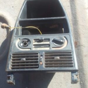 Front view of a used Fiat Uno center dashboard air vent showing three horizontal vent slots with attached cont