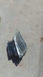 Front view of a used car dashboard air vent, black plastic with silver trim, in good condition.Front view of a