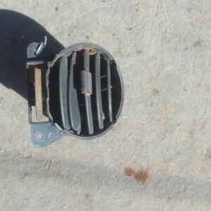 Front view of a used air vent for Mahindra Genio dashboard showing horizontal slats and mounting points.Front