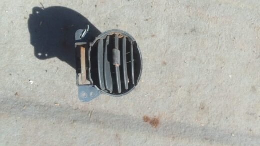 Mahindra Genio Dash Airvent - Used Front view of a used air vent for Mahindra Genio dashboard showing horizontal slats and mounting points.Front
