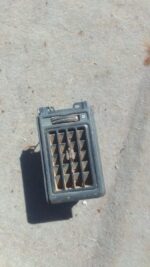 Front view of used Opel Kadett dashboard air vent with control knob and surrounding black trim.Front view of u
