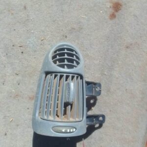 Close-up of a used Mercedes W203 dashboard air vent, front view showing vent slats and surrounding frame.Close