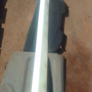 Right side skirt for 2005 Chery J5 shown from side angle, used condition with visible mounting points.Right si