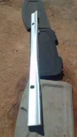 Left side skirt for BMW E36, used condition, shown from side angle on a plain background.Left side skirt for B