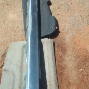 Right side skirt for BMW F10, shown from side angle, used condition with slight wear marks visible.Right side