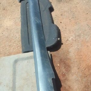 Left side skirt for Jeep Cherokee shown from side angle, used condition.Left side skirt for Jeep Cherokee show